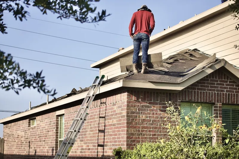 Professional roofer working on a residential roof in Daytona Automall